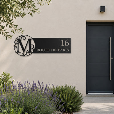 Plaque de rue avec monogramme personnalisée, acier découpé au laser, à côté de la porte d'entrée · Steelmonks